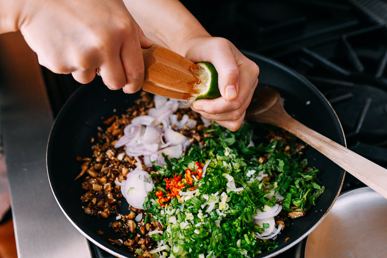 Juicing lime into mushroom larb