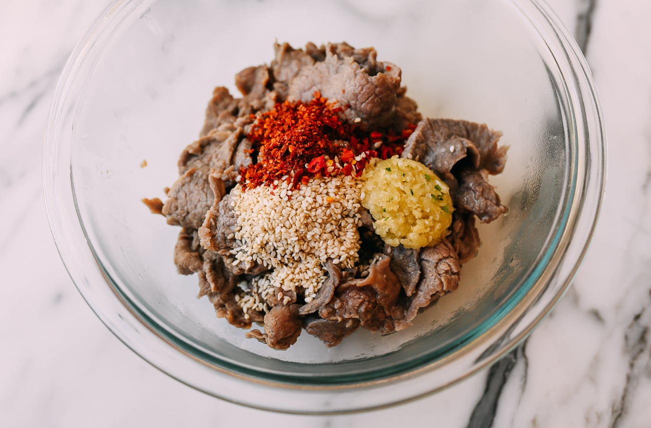 Sugar, chili, garlic and sesame seeds on beef