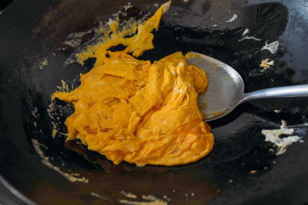 Partially cooked scrambled eggs in wok