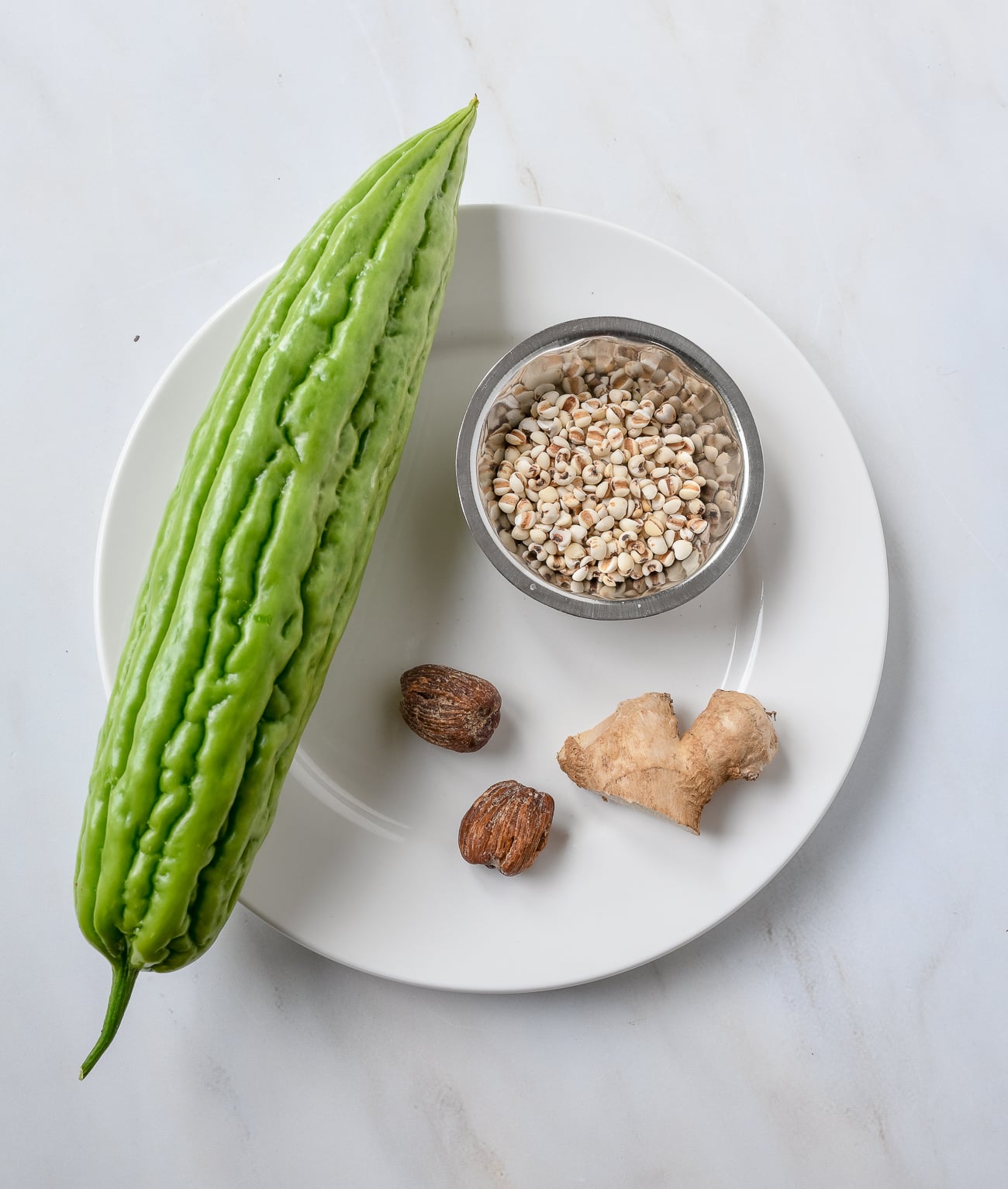 Bitter Melon, Dates, Barley, and Ginger on white plate