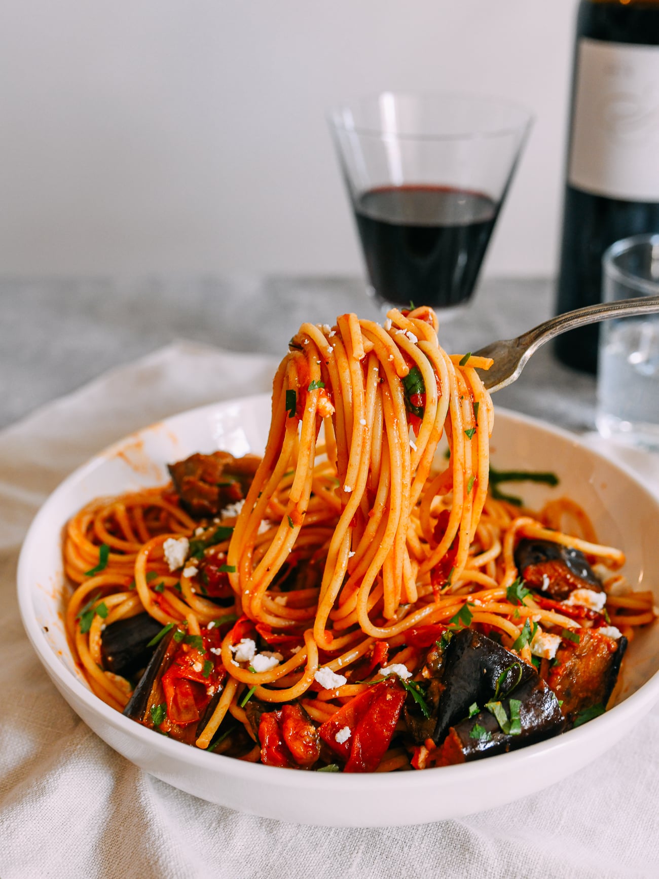 pulling up a forkful of pasta alla norma