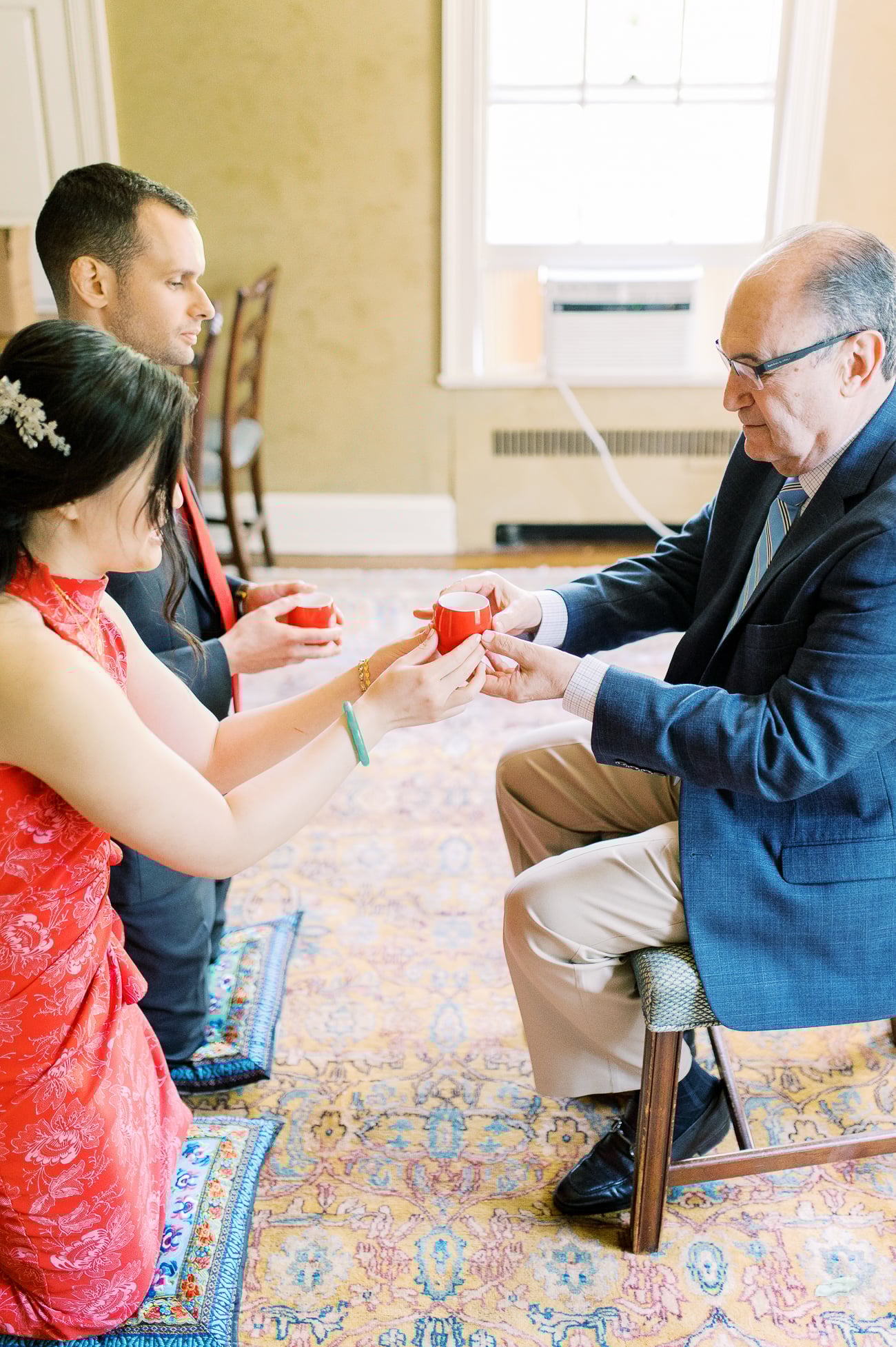 Sarah and Justin serving tea to Justin's dad