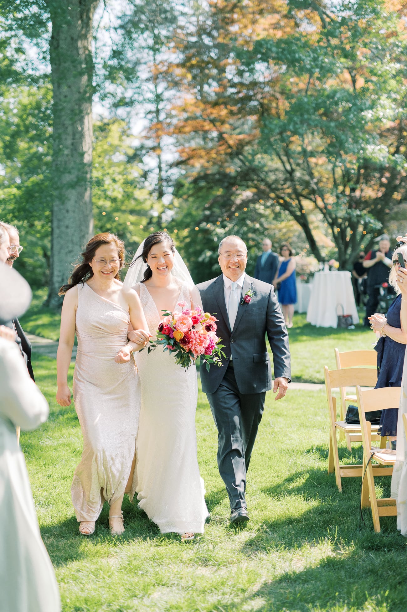 Sarah walking down the aisle with her parents