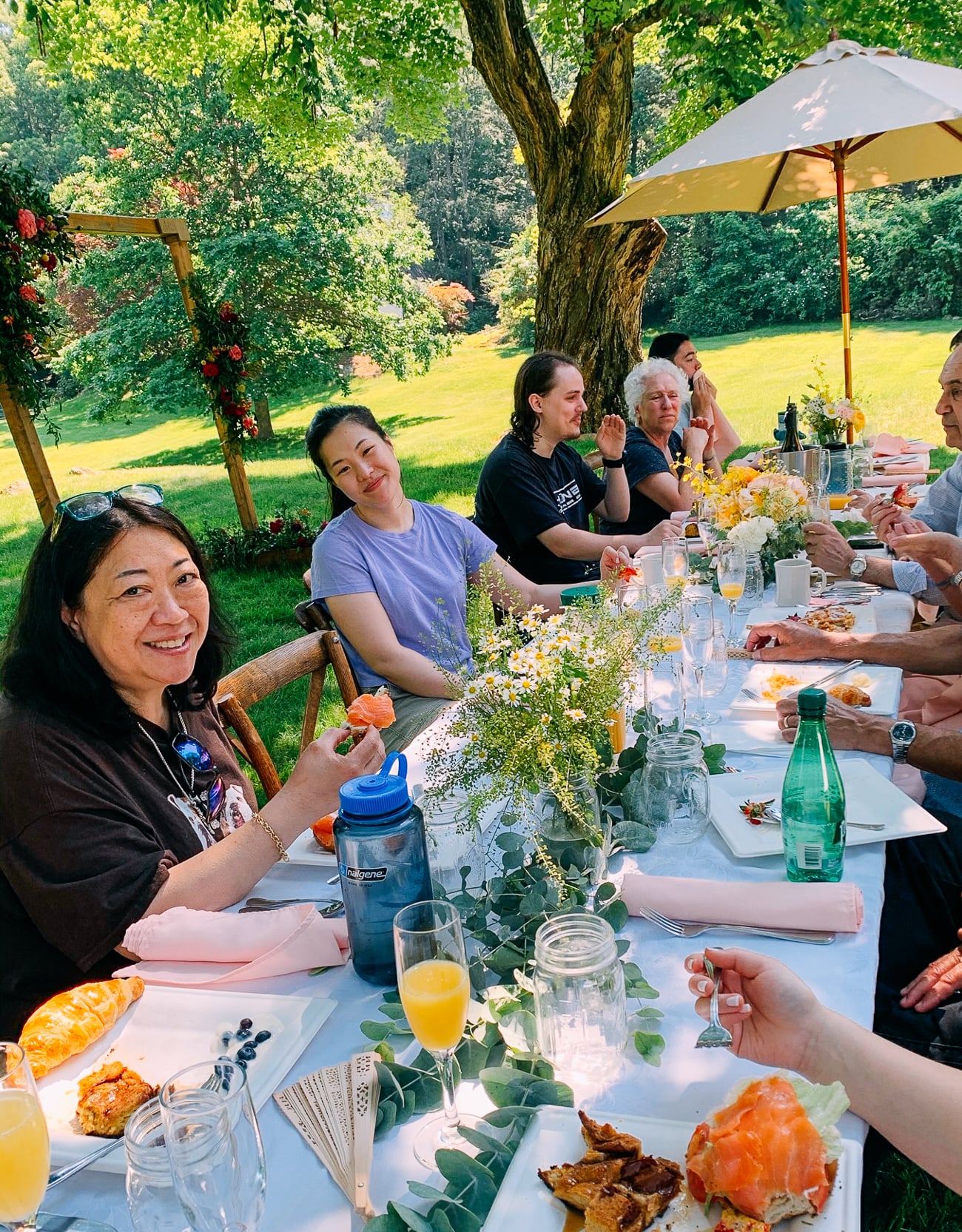 Family enjoying brunch outside after wedding