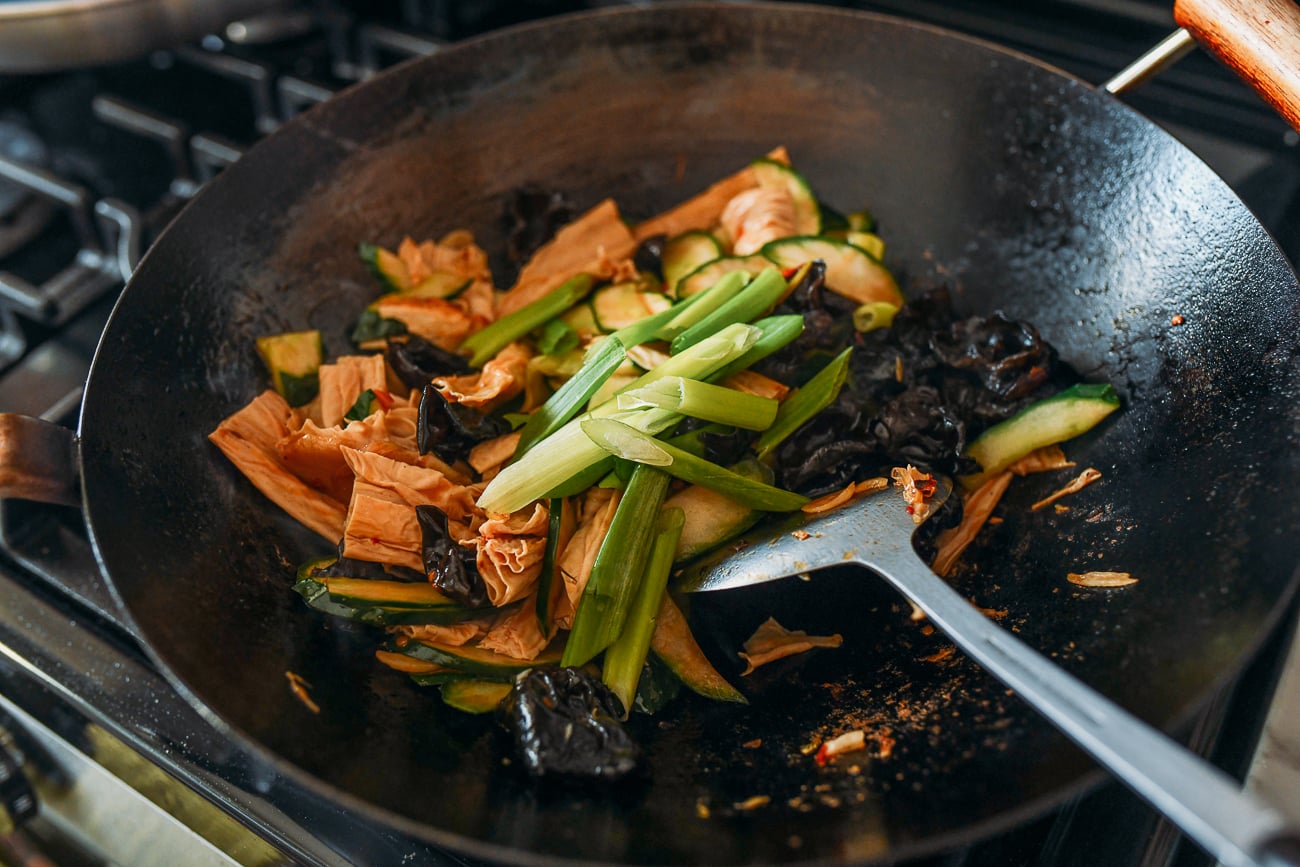 Adding green parts of the scallions to a stir-fry
