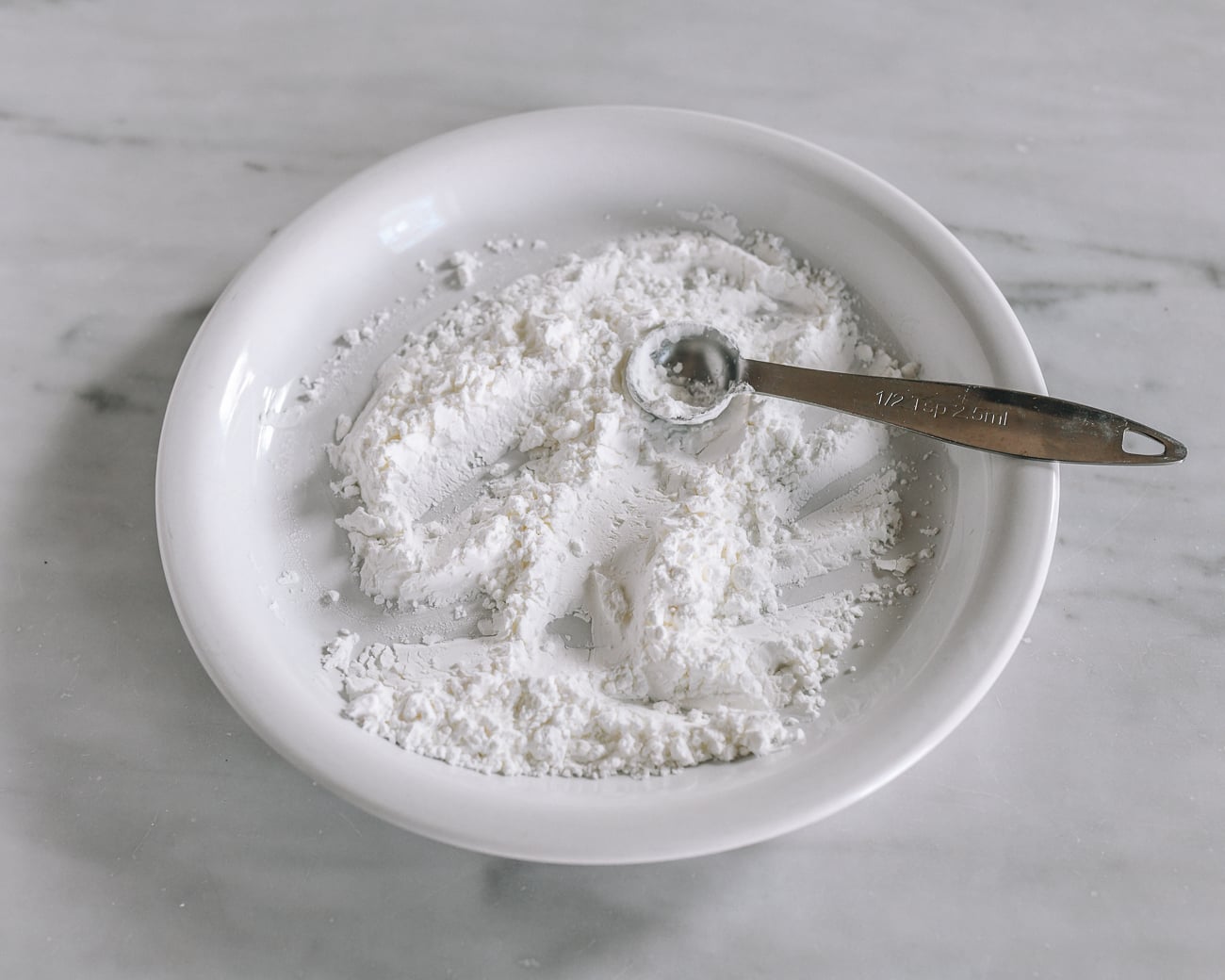 Mixture of cornstarch and salt in shallow white dish