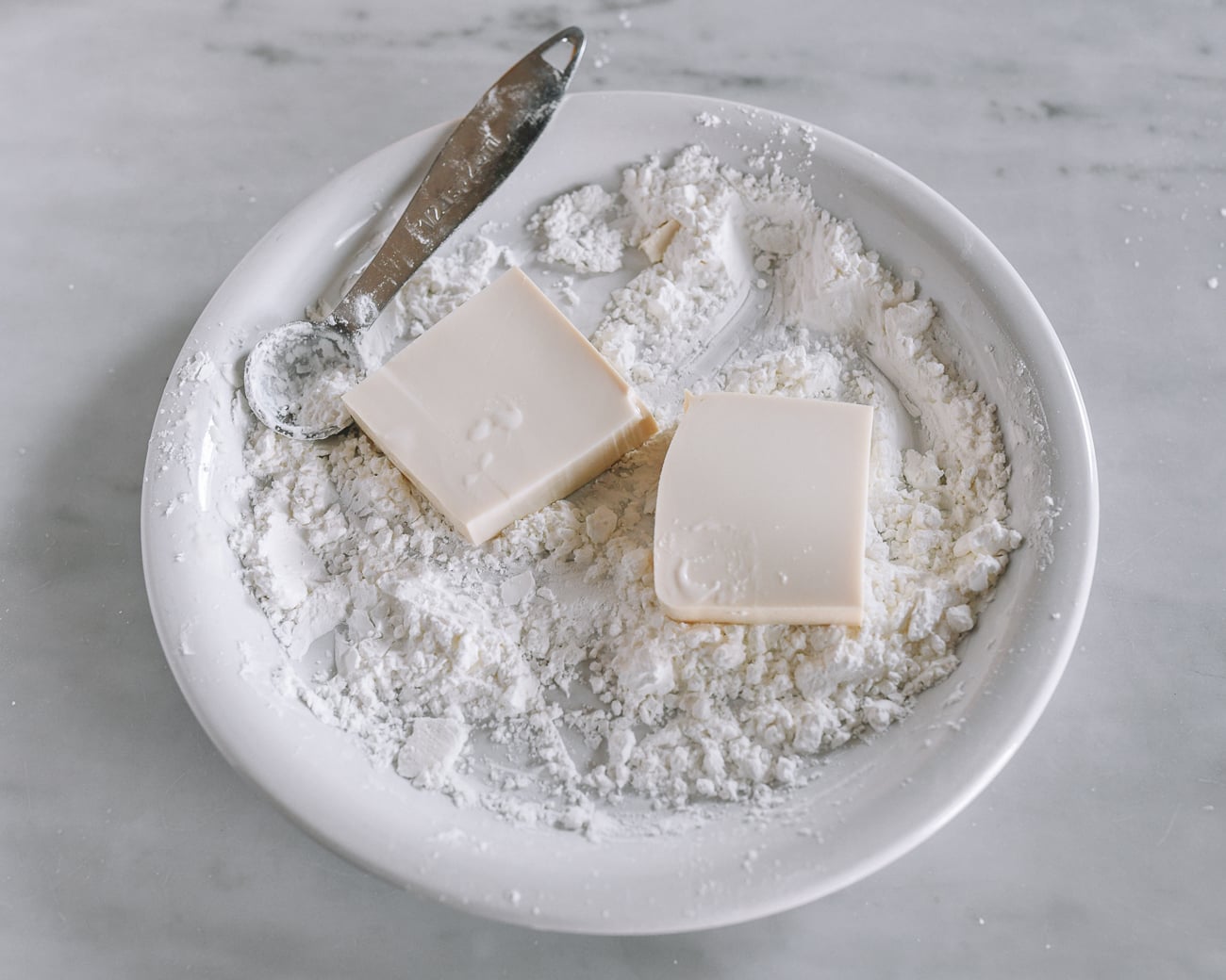 Dredging tofu in cornstarch