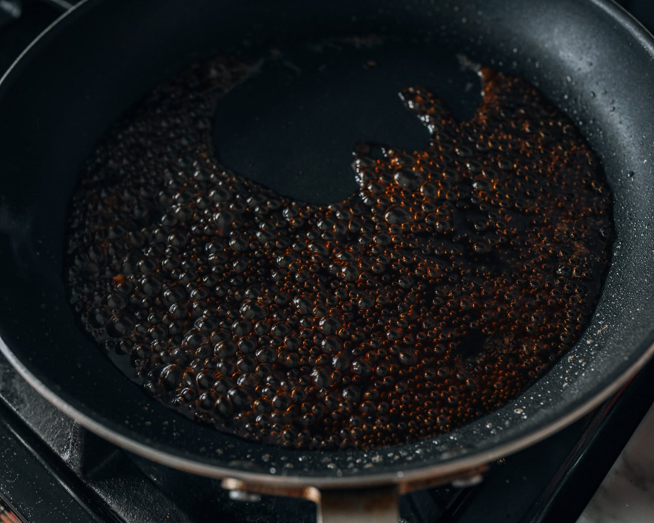 Simmering sauce mixture in pan