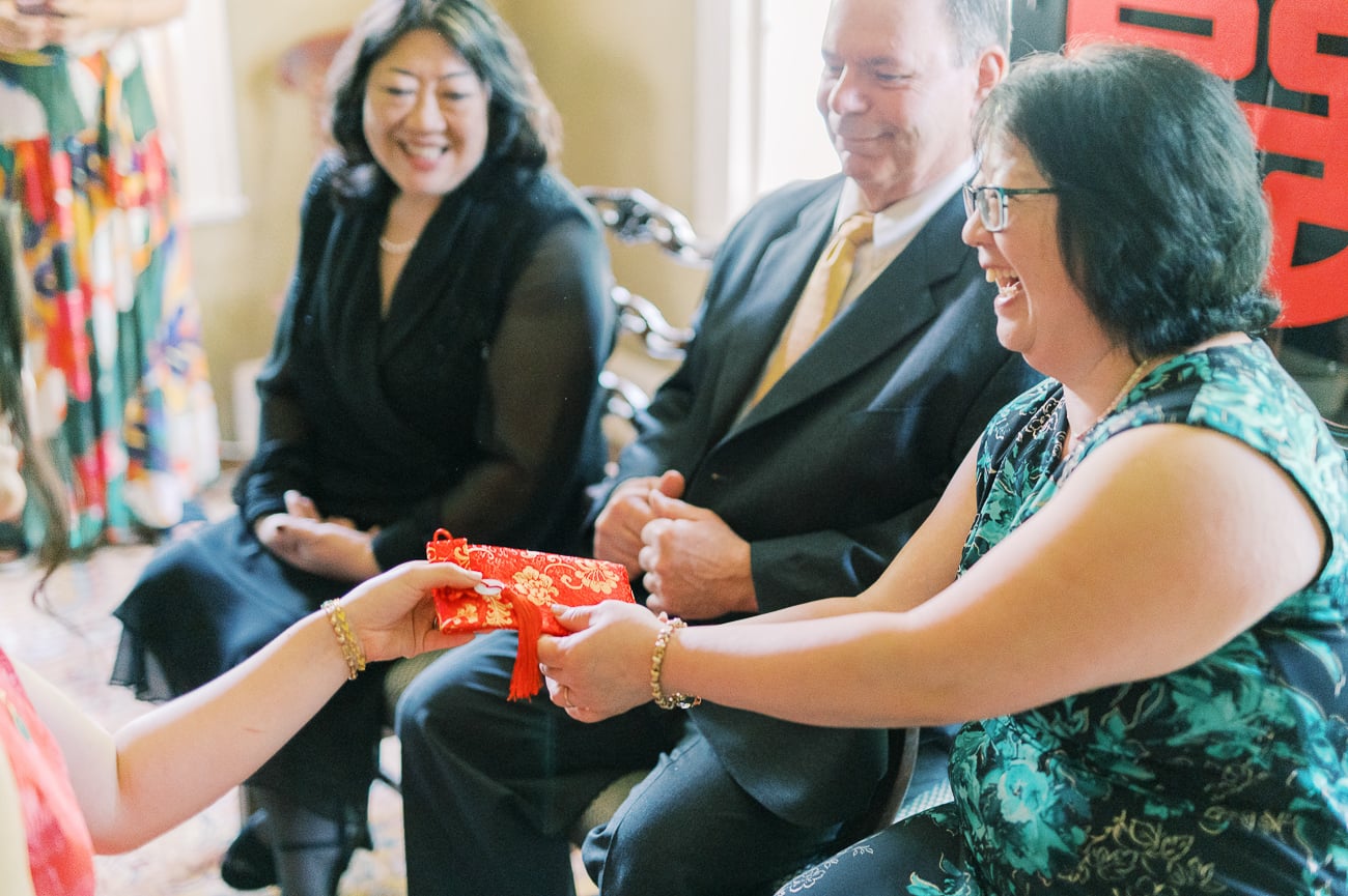 Sarah's aunt giving gift during tea ceremony