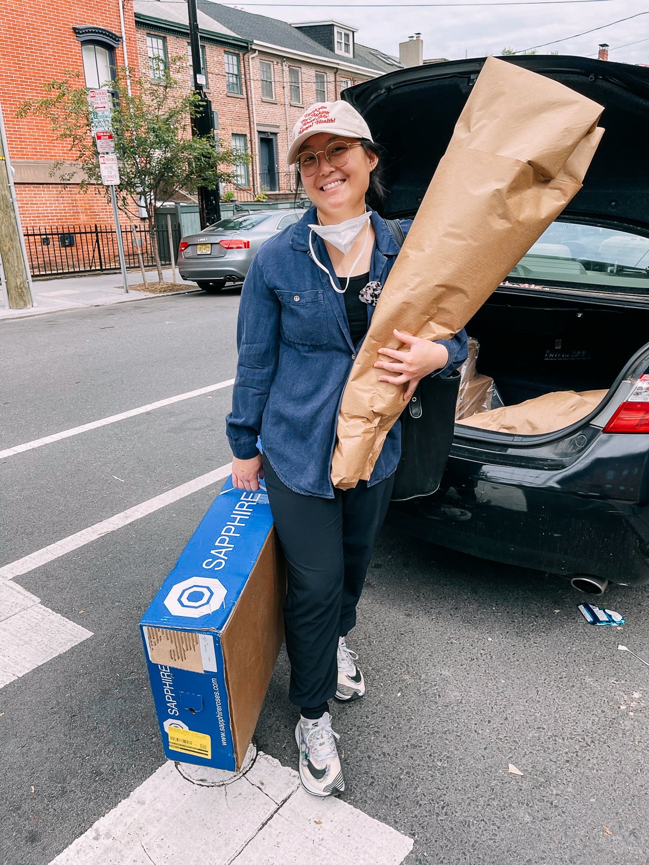 Kaitlin holding packages of cut flowers