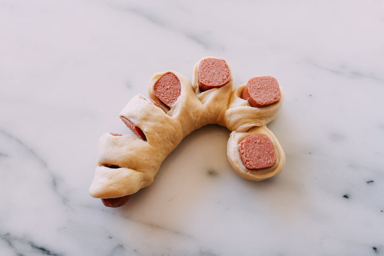 Arranging dough for Chinese bakery style flower hot dog buns