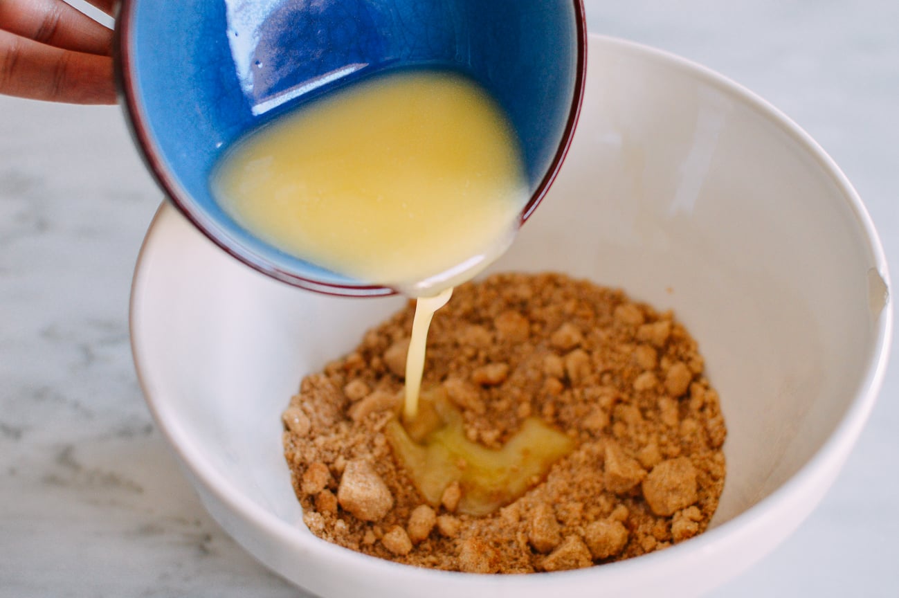 Adding melted butter to crumb mixture
