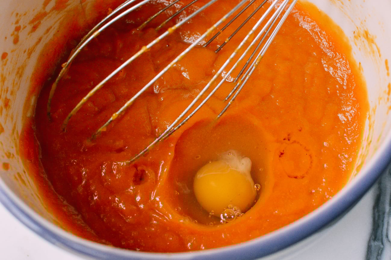Beating egg into pumpkin mixture