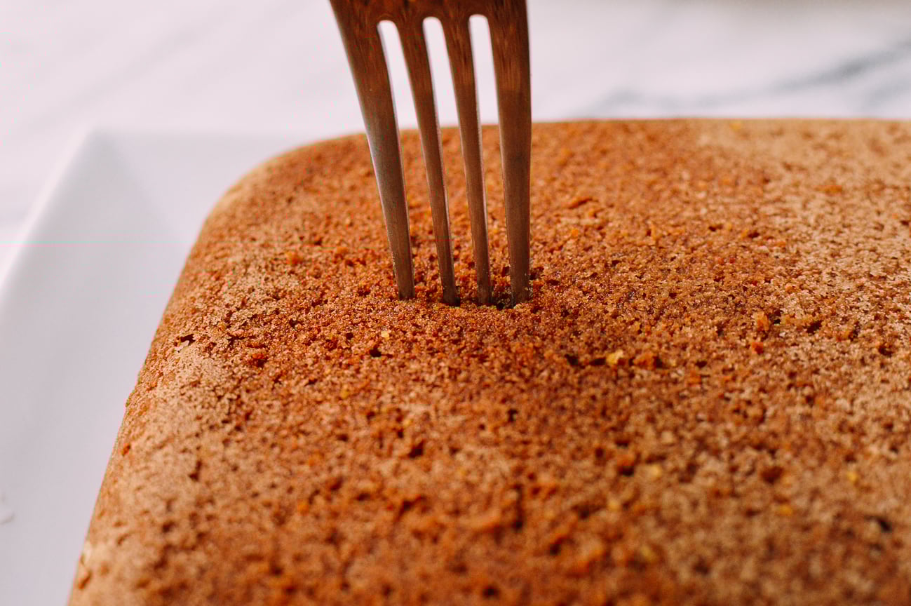 Poking cake with a fork