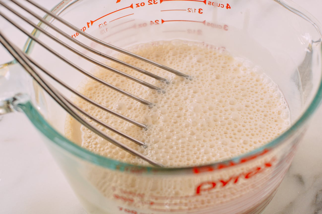 Whisking together three milks in measuring cup