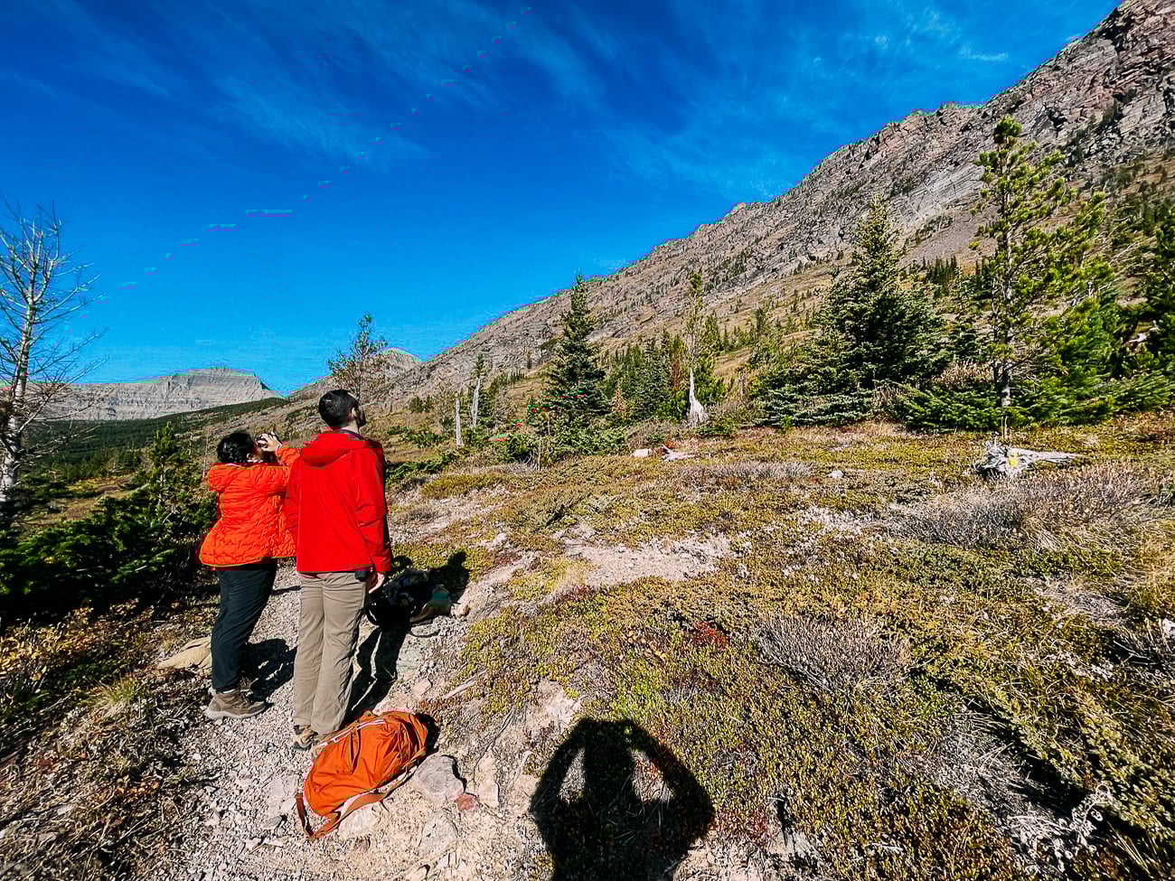 Kaitlin looking through binoculars at mountain goats