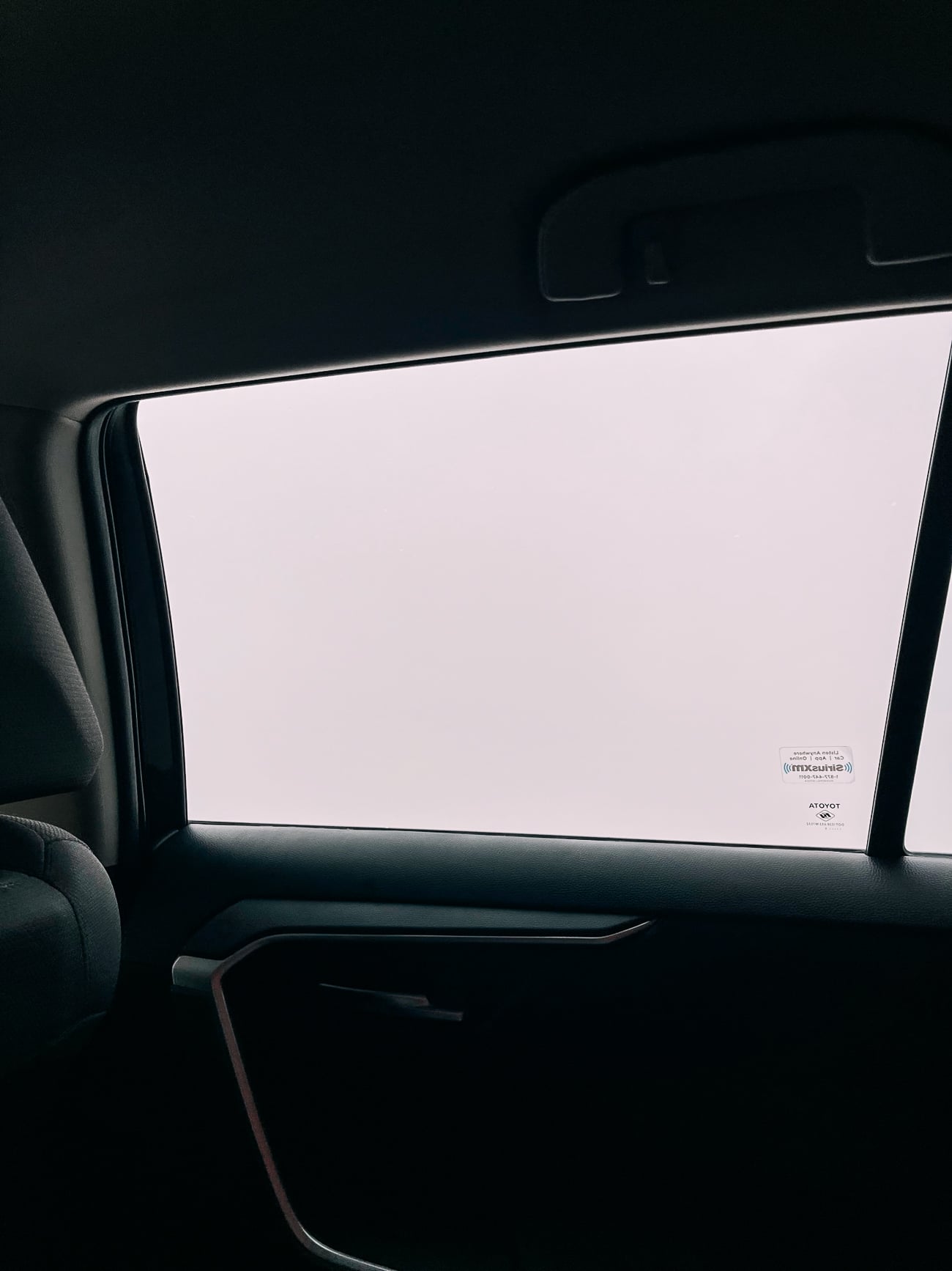 View of cloud outside car window.