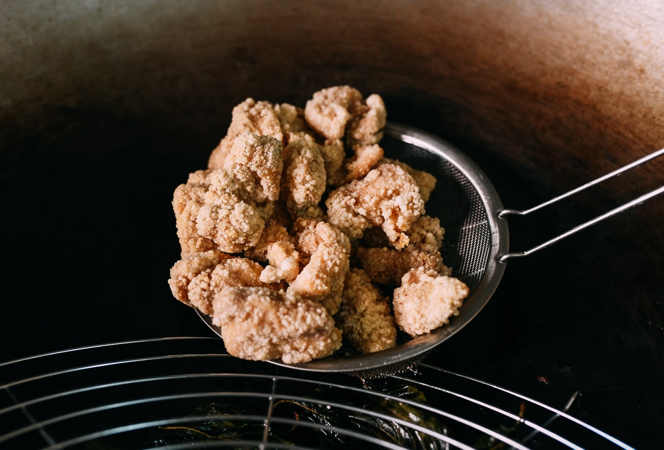 Pulling chicken out of frying oil