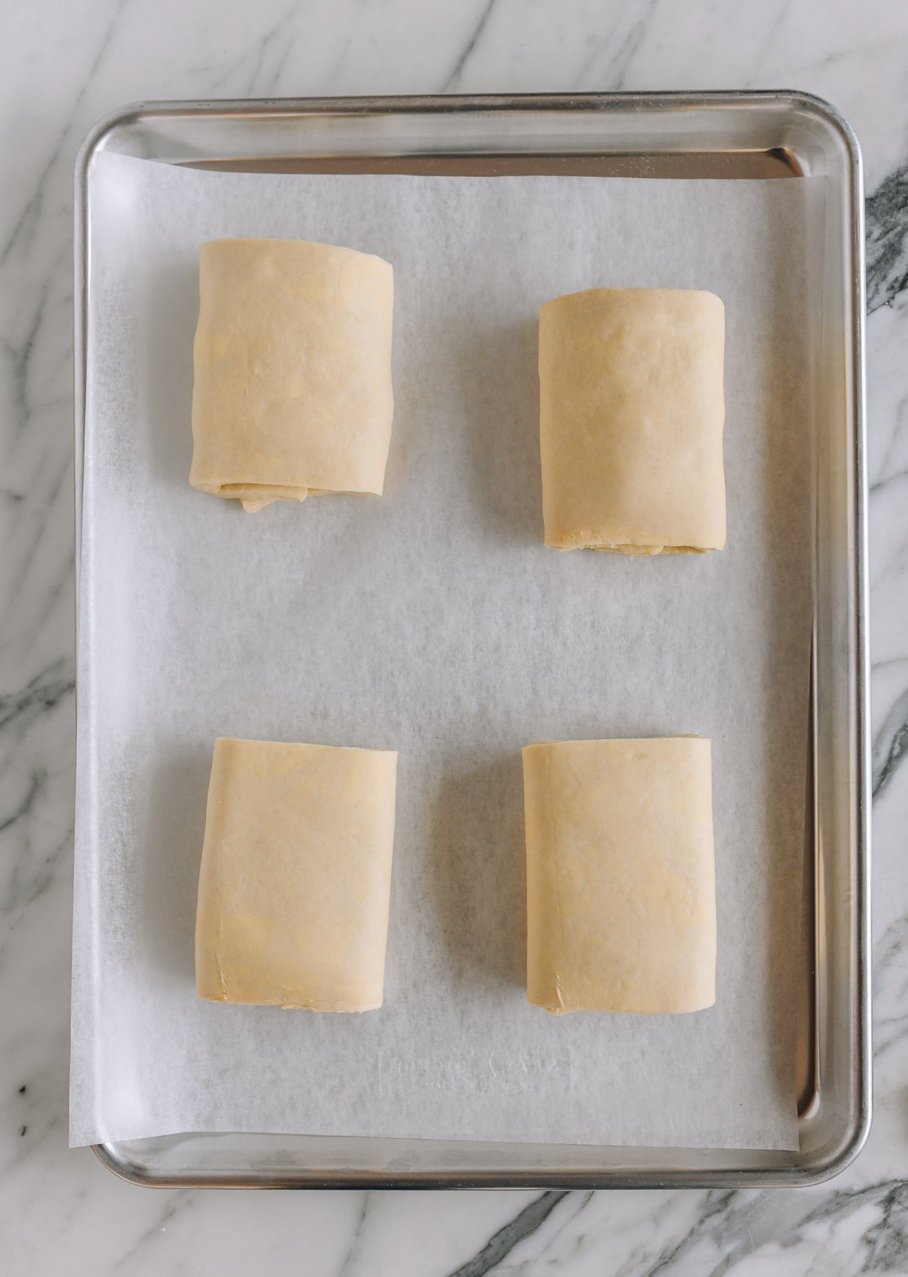 ham and cheese croissants on baking sheet before baking