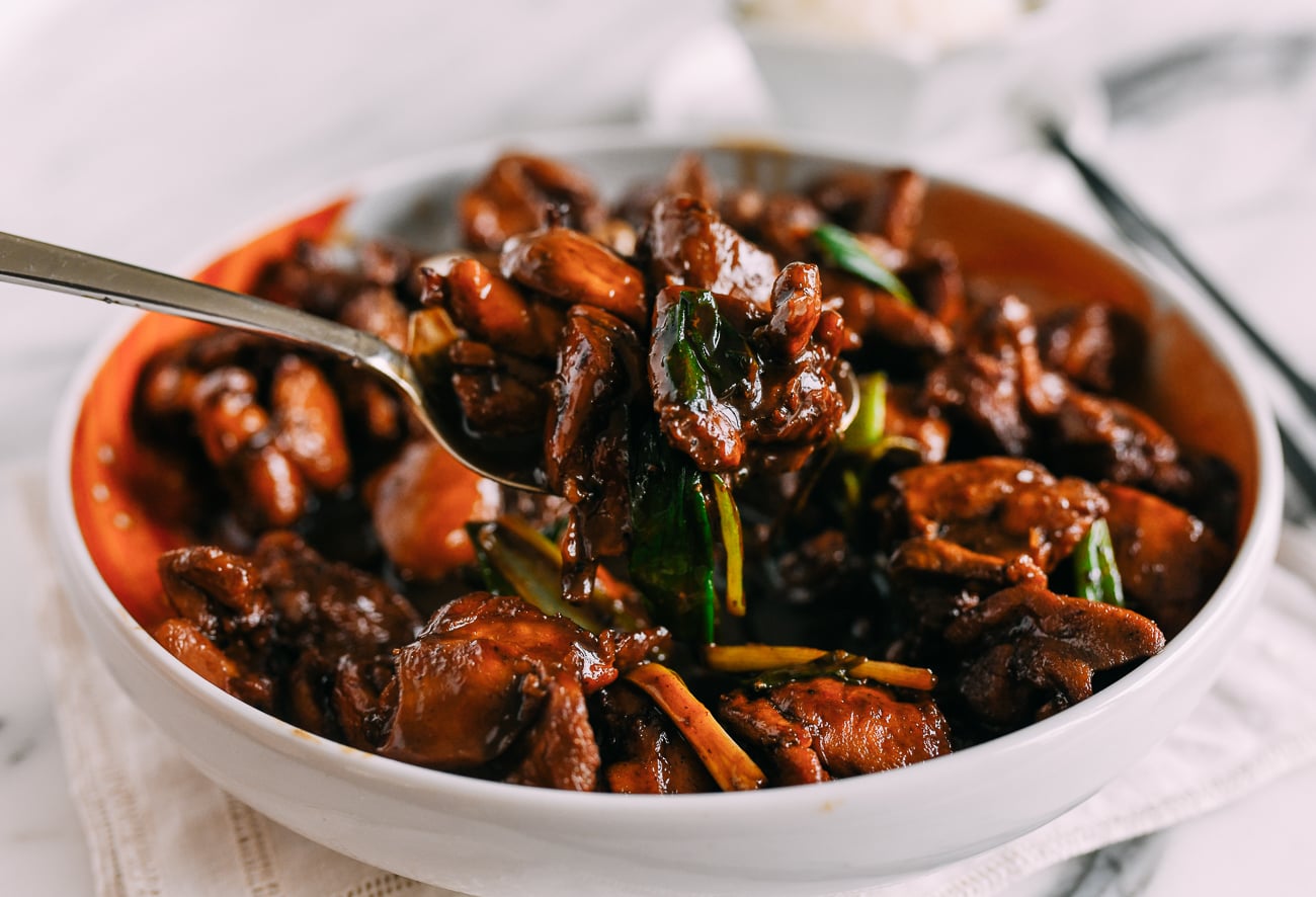 Picking up a scoop of Chinese red braised chicken