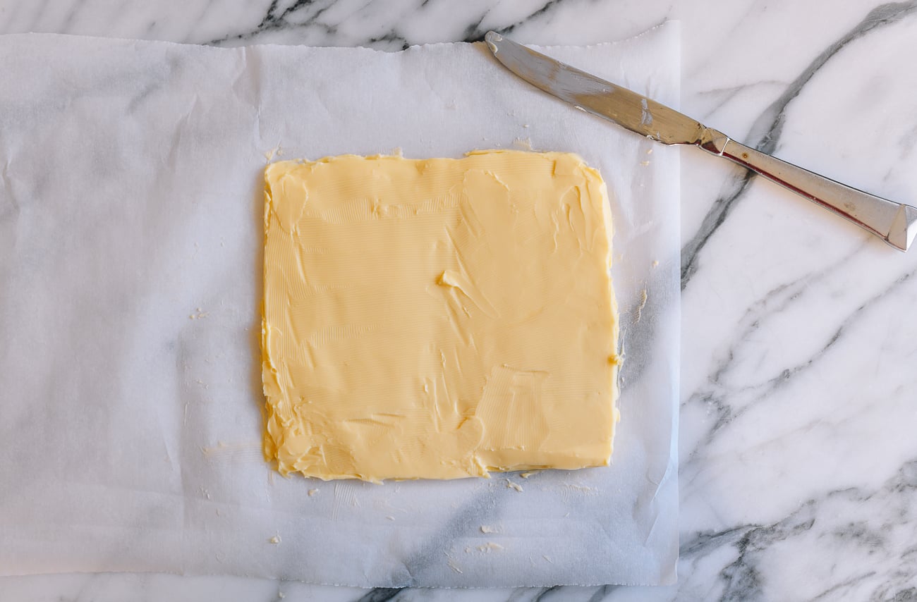 Square of butter on parchment paper