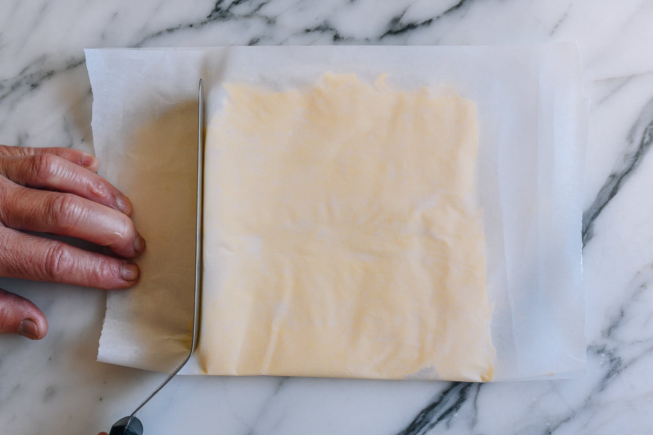 Using offset spatula as a straight edge to form butter square