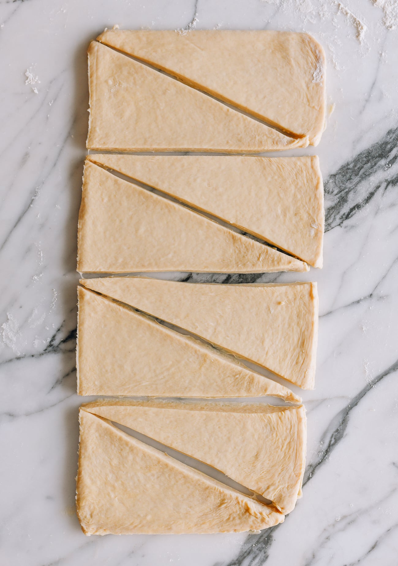 Dough sliced into rectangles to make croissants