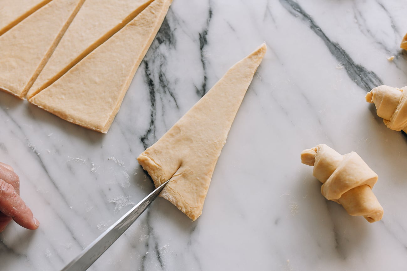 Slicing into base of dough triangle