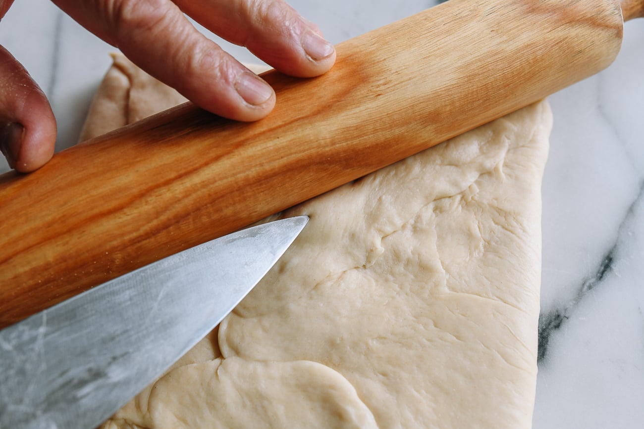 Popping air bubble in dough with knife