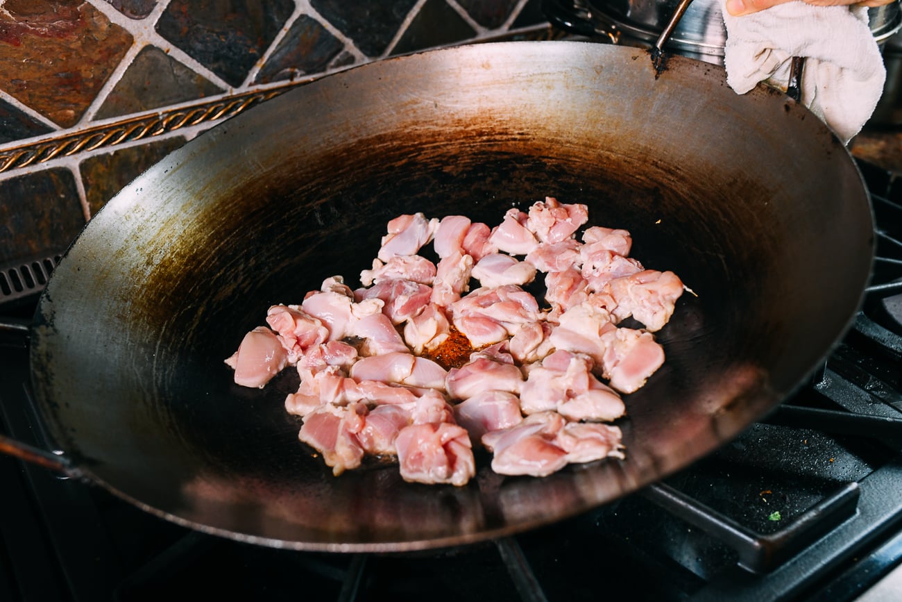 searing chicken in wok