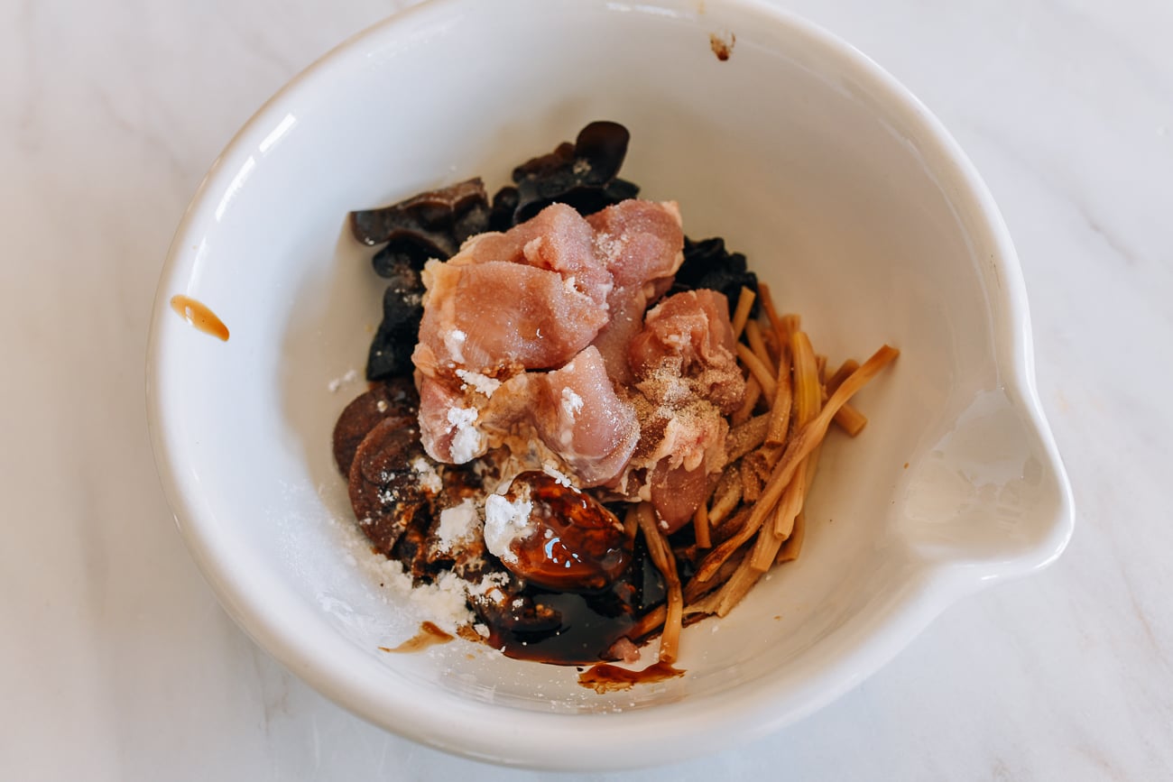 Chicken, mushrooms, lily flower, and marinade ingredients in bowl