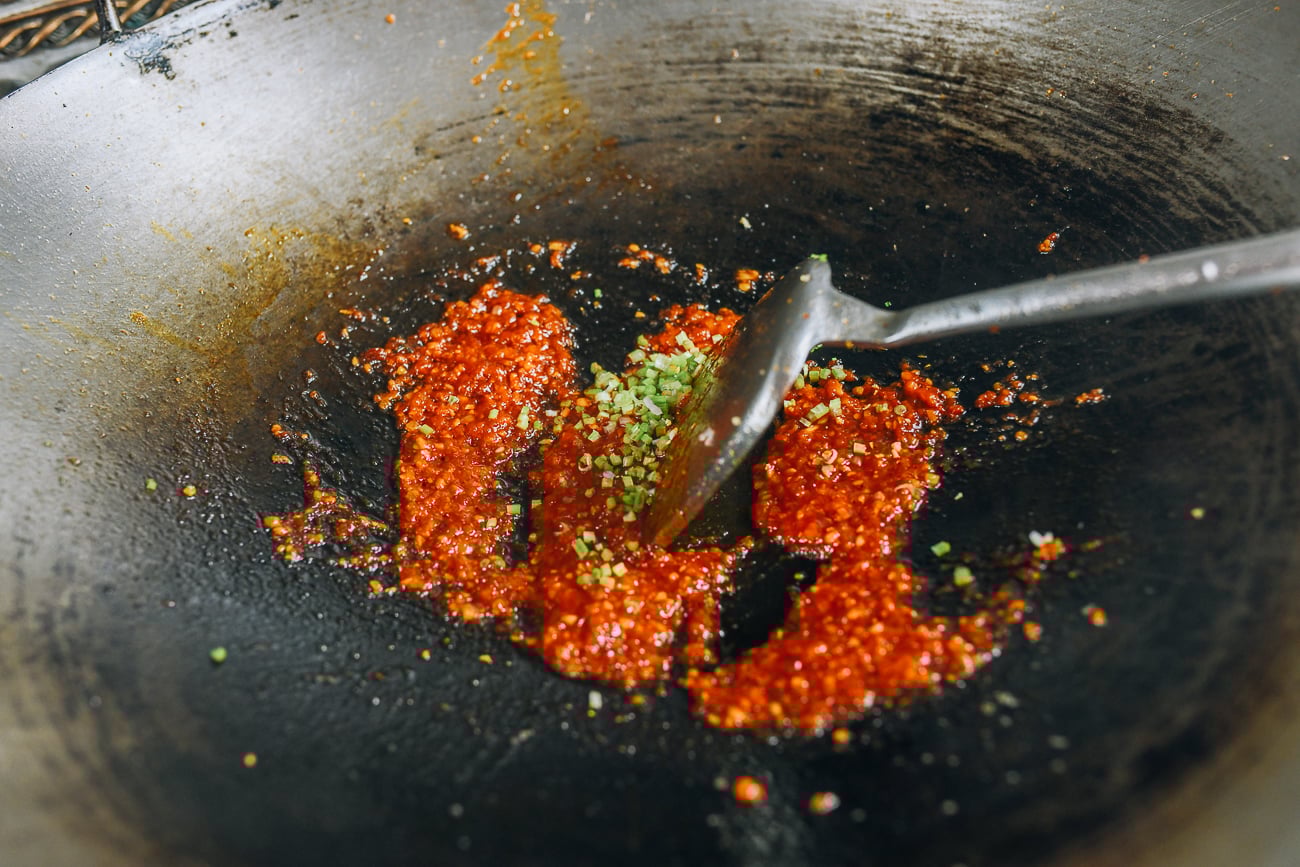 Stirring cilantro stems into sauce