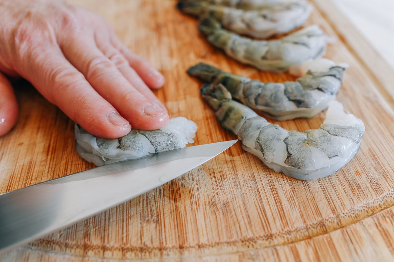 Slicing through back of tiger shrimp
