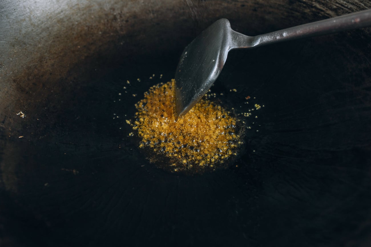 Cooking ginger in oil in wok