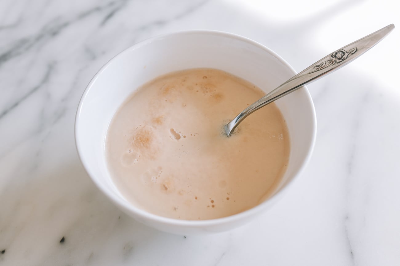 Blooming yeast in small white bowl