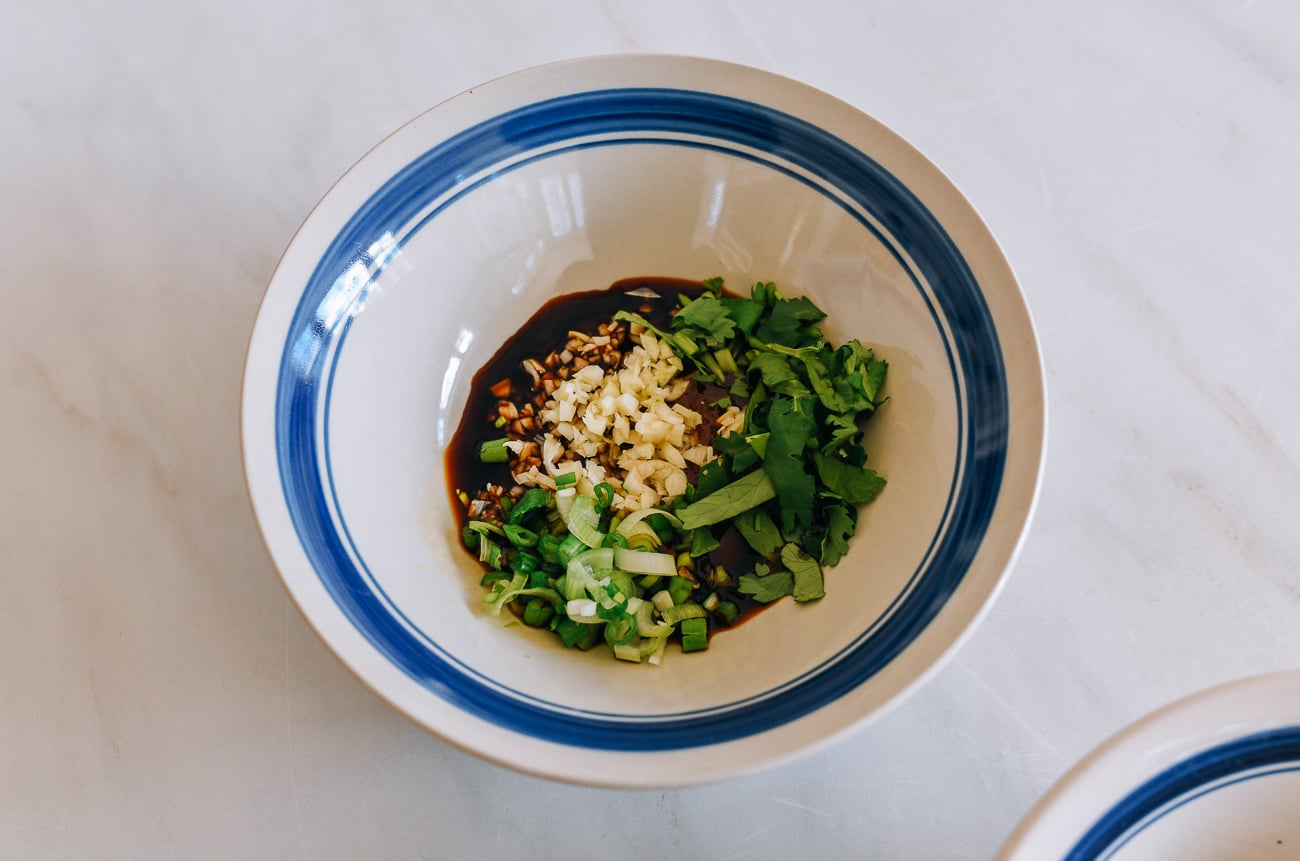 garlic, scallions, cilantro, oyster sauce, and soy sauce in bowl