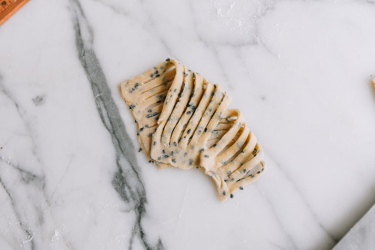 Folding sesame dough into fan shape