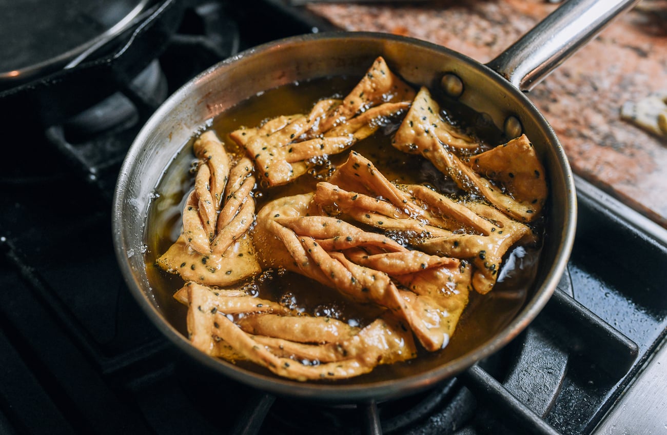 Frying sesame twists in hot oil