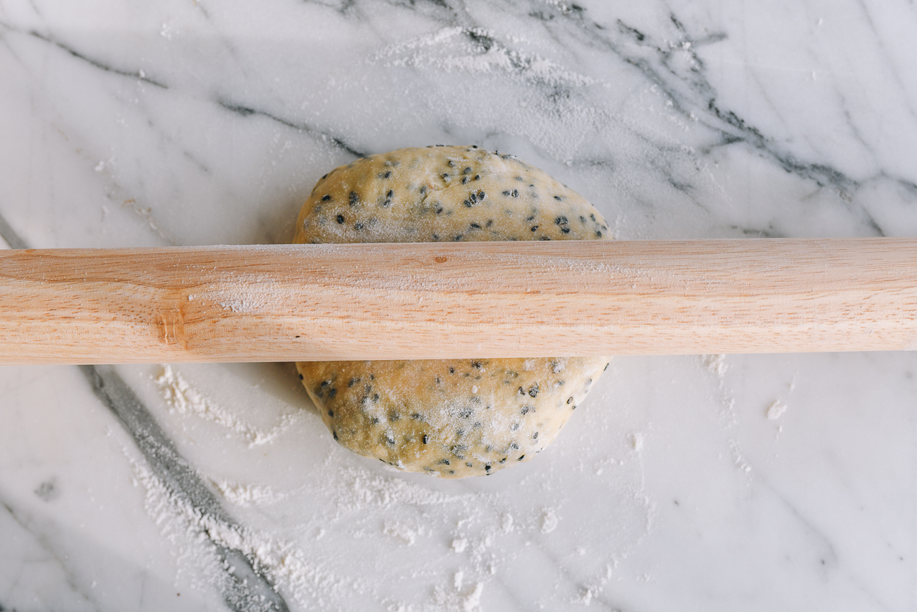 Beginning to roll out sesame dough with rolling pin