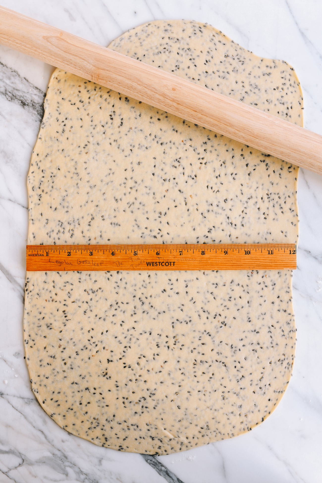Measuring dough sheet with ruler