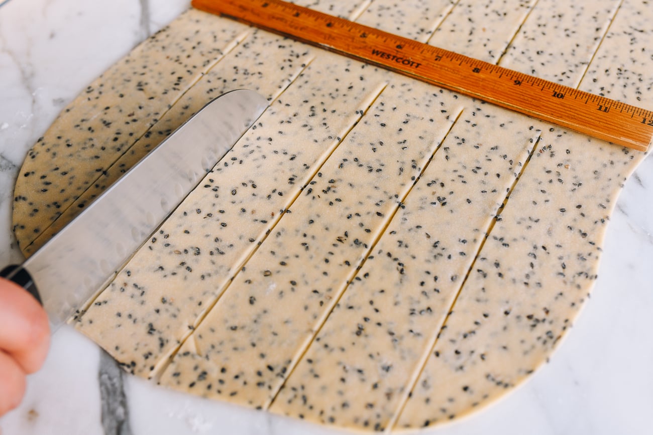 Cutting sesame dough into strips