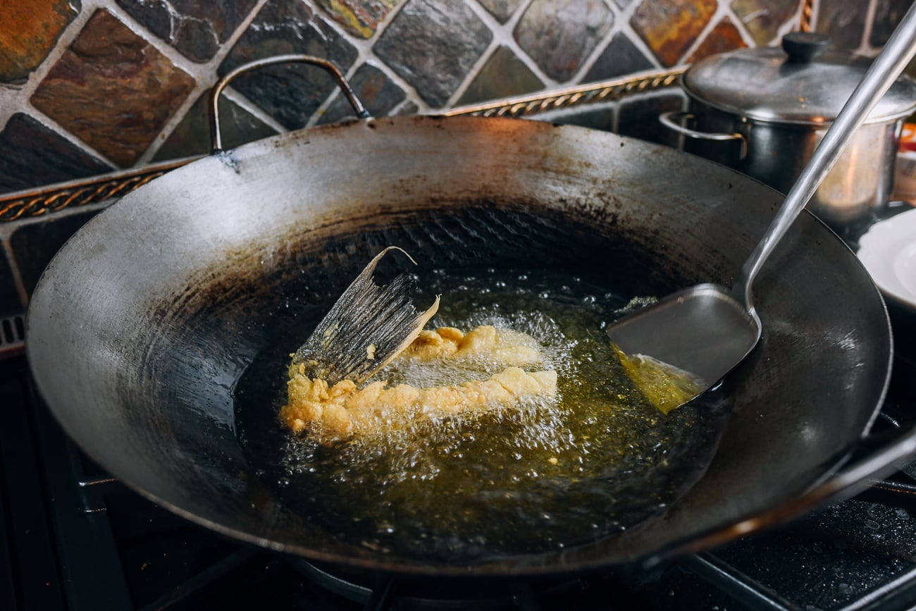 Frying fish fillets in wok