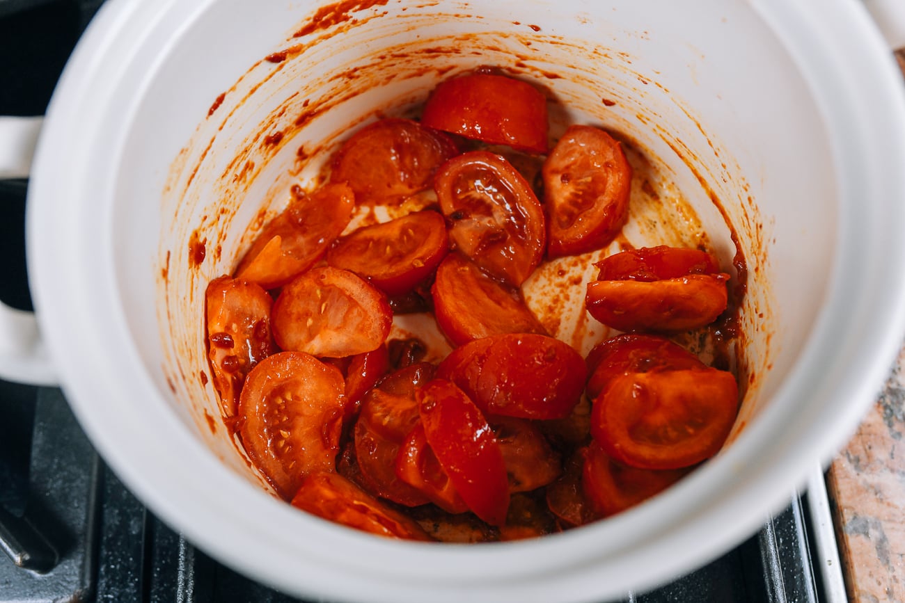Cooking tomatoes in pot with oil and tomato paste