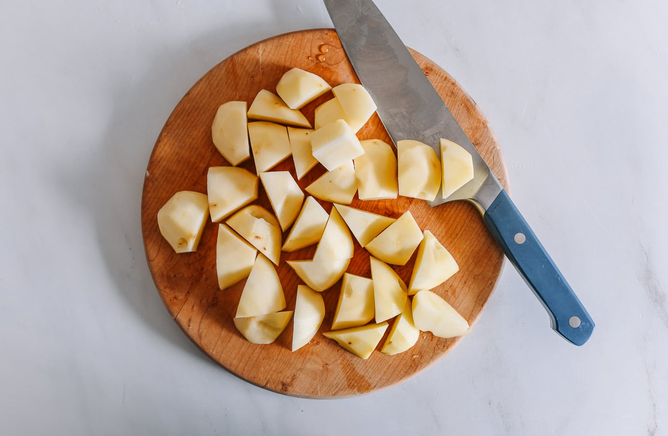 Potato chunks on cutting board