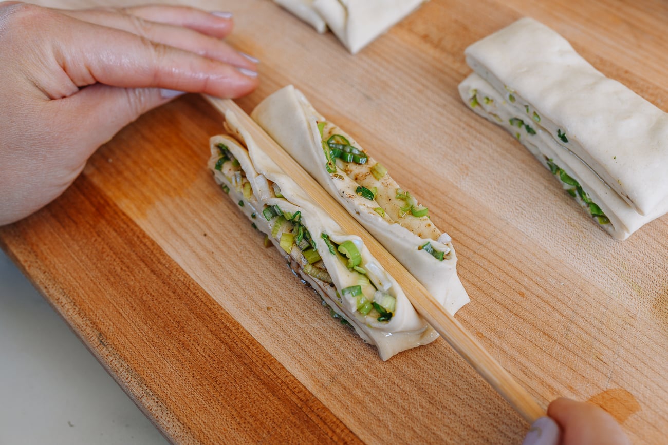Pressing dough down lengthwise with chopstick
