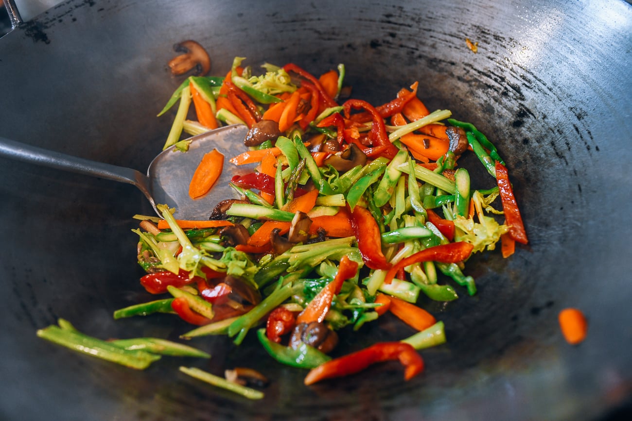 Stir-frying mixed vegetables in a wok
