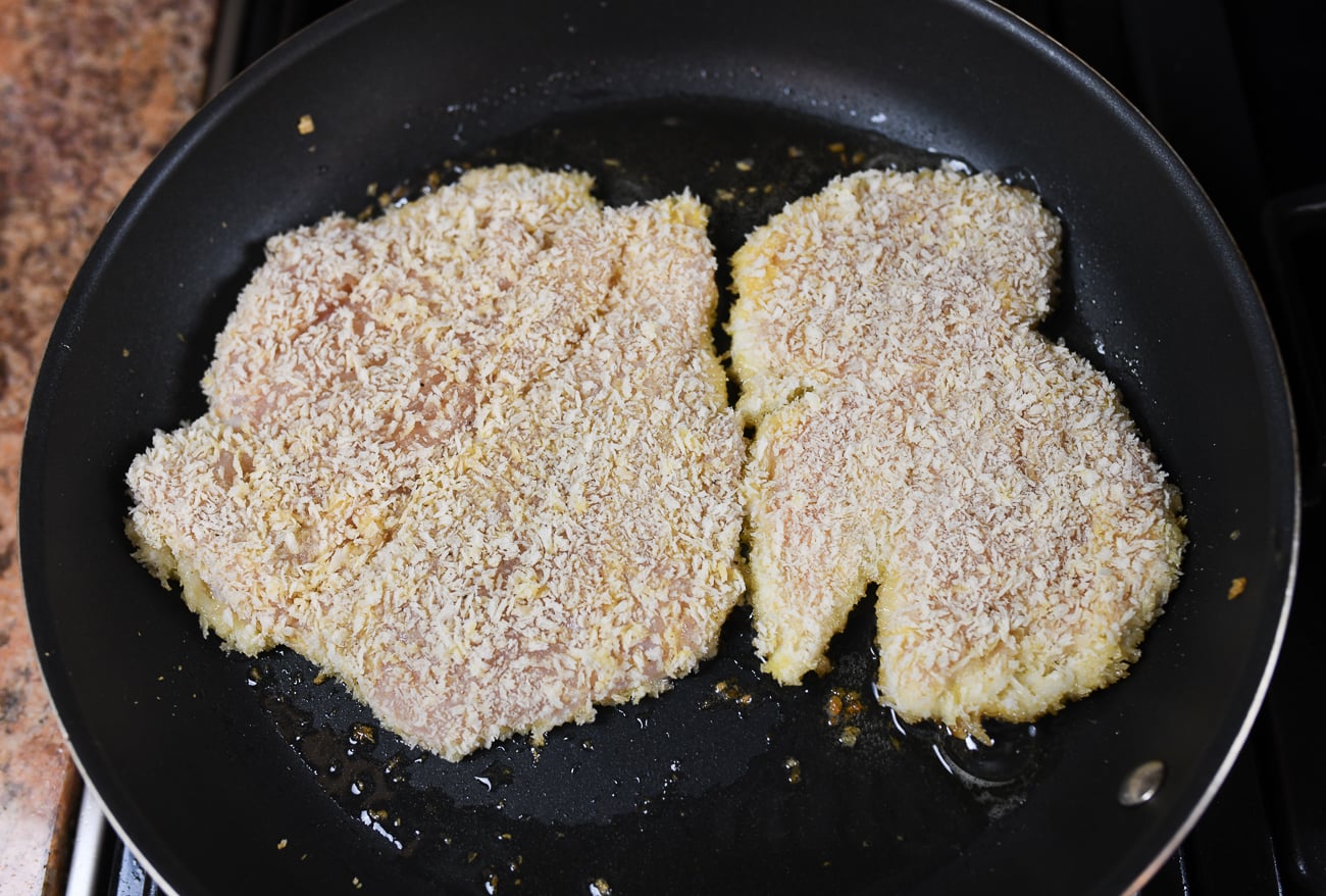 cooking panko breaded chicken cutlet in pan