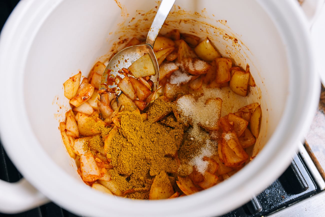 adding curry powder to onions