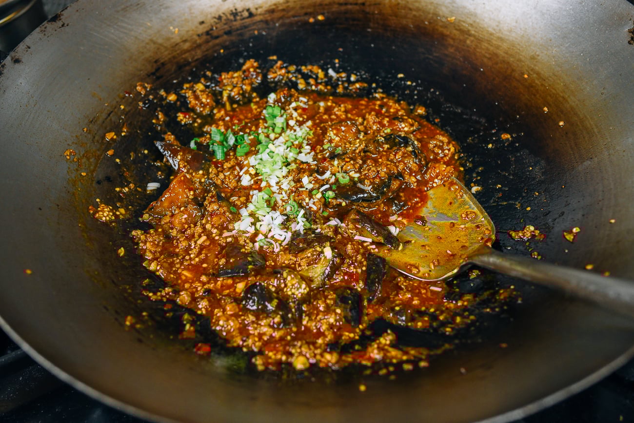 stirring scallions into mapo eggplant