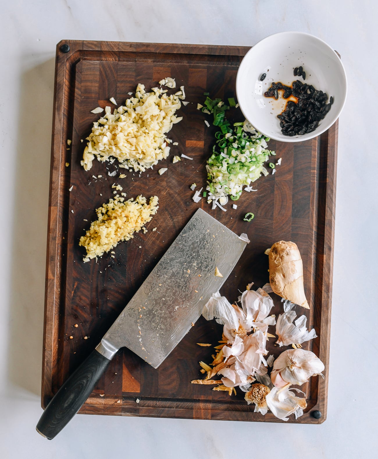 cutting ginger, garlic, and scallions for mapo eggplant